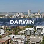 A vibrant aerial view of Darwin's cityscape showcasing modern office buildings, residential apartments, and the waterfront, highlighting Darwin's urban development and scenic coastal location.