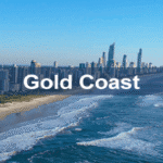 A panoramic view of the Gold Coast featuring iconic skyscrapers and pristine beaches, showcasing the vibrant coastal cityscape of Queensland, Australia.